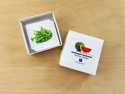 Montessori fruits and vegetables flashcards in a storage box.
