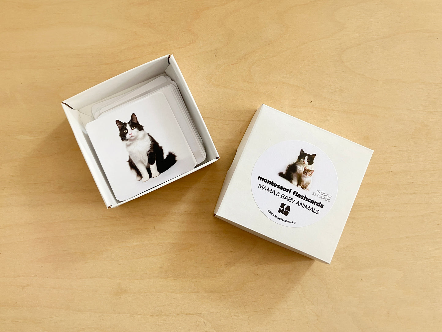 Montessori mama and baby animals pairs, in a box with mother cat