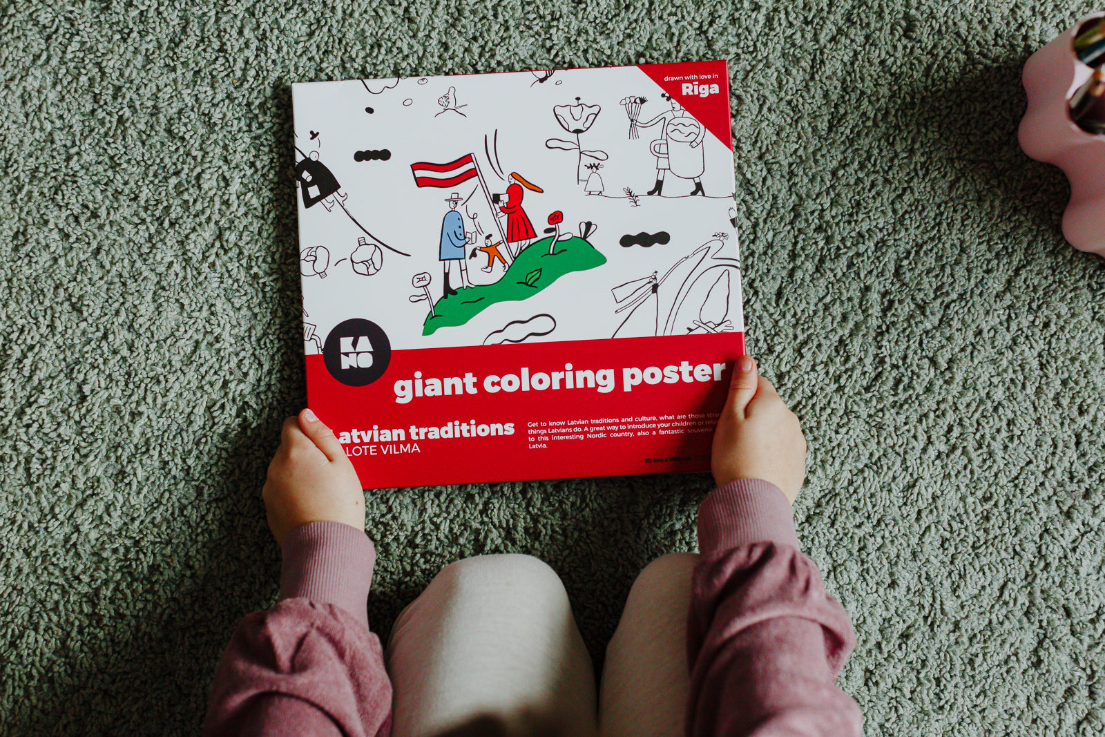 XXL giant coloring poster Latvian traditions, isbn 978-9934-8993-1-7,  box of the poster in the hand of a child