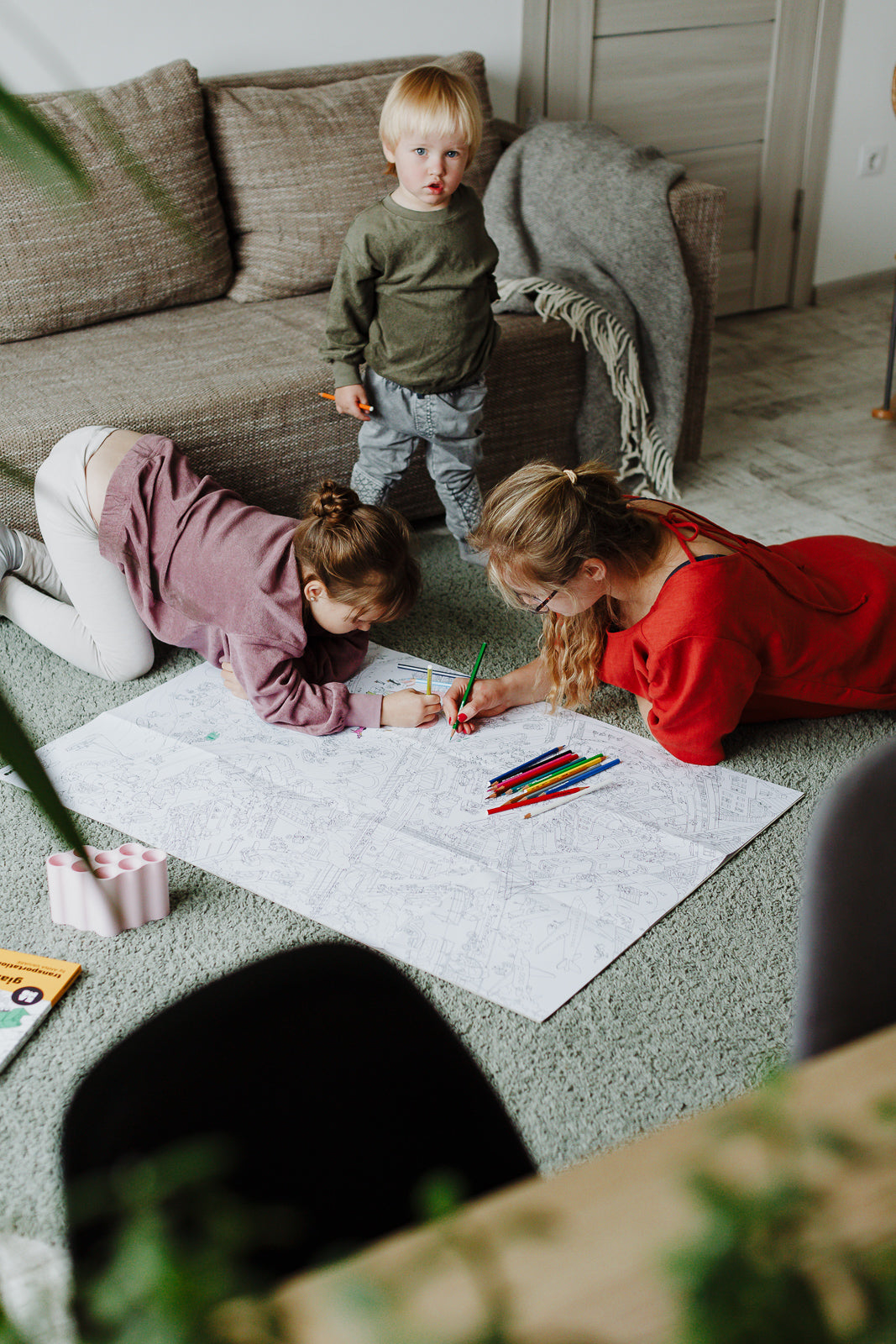 XXL coloring poster Transportation by Anna Vaivare, ISBN:9789934899355, two kids with mother having fun coloring with caran d'ache pencils